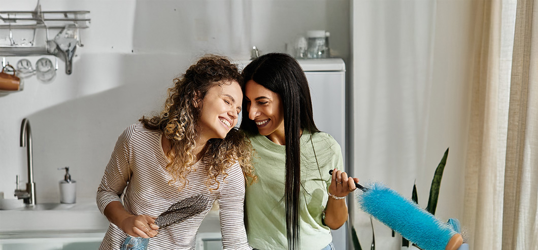 HappyLesbianCoupleEmbraceInTheirStylishApartmentSharingSmiles | Evok Advertising Effective Healthcare Marketing Beyond the Stigma