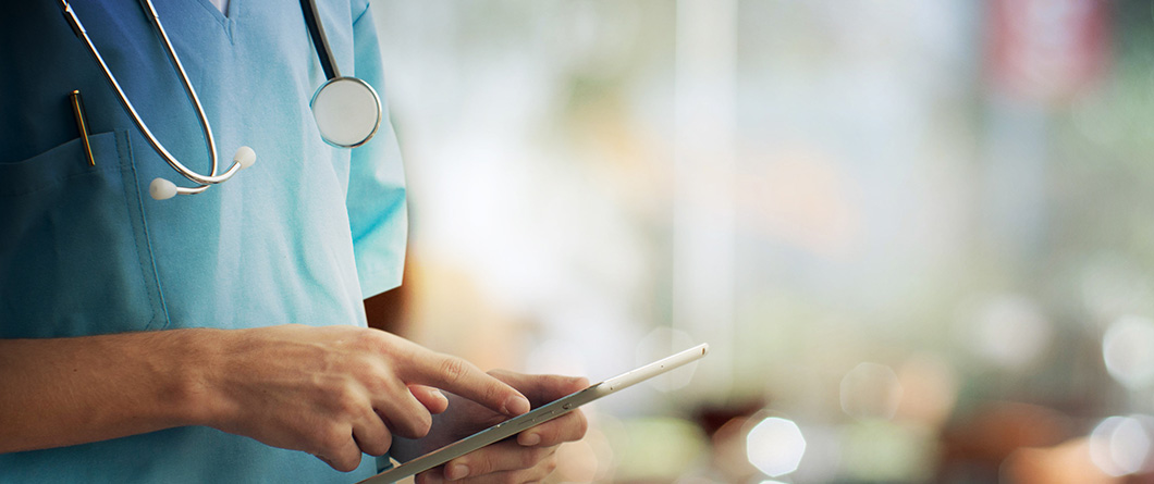 HealthcareAndMedicineDoctorUsingADigitalTablet | Evok Advertising Effective Healthcare Marketing Beyond the Stigma