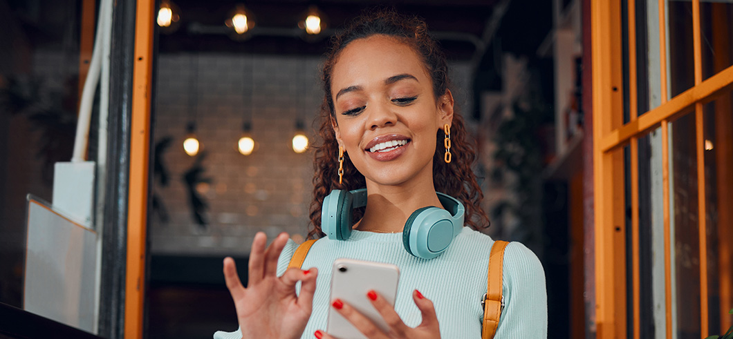 HappyGenZYoungWomanWithSmartphoneSocialMediaFashion | Evok Advertising Effective Healthcare Marketing Beyond the Stigma