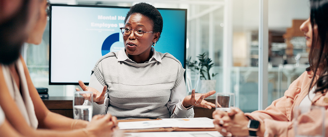 OfficePeopleAndBusinesswomanWithDiscussionInMeetingEmployeesWellness | Evok Advertising Measuring Impact with Behavioral Change in Public Health Campaigns